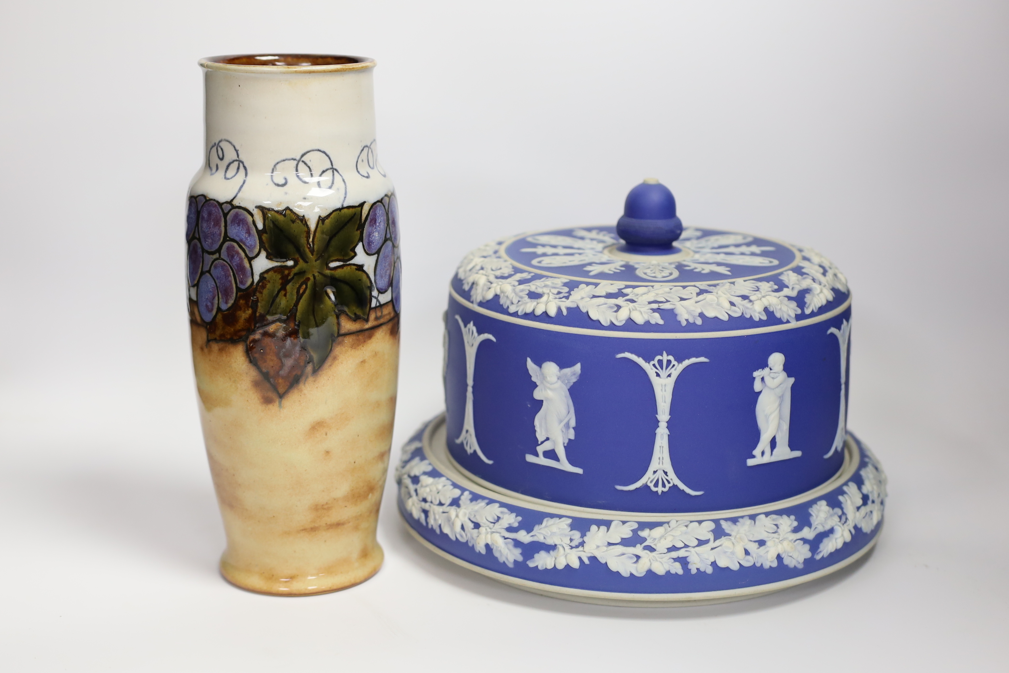 A Victorian blue Jasperware cheese dome with a on knop and Royal Doulton grapevine vase, largest 26cm high